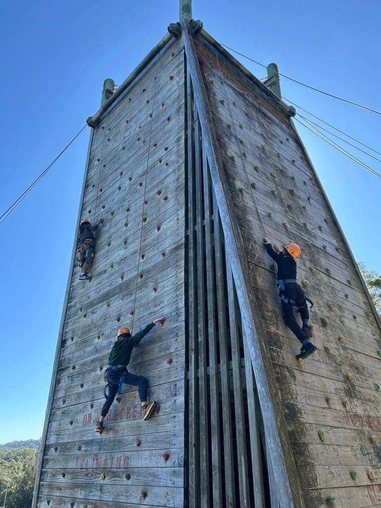 Students climbing a rock wall at Stage 3 camp