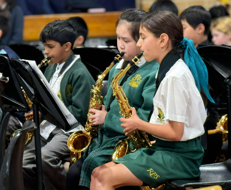 3 students playing the saxaphone