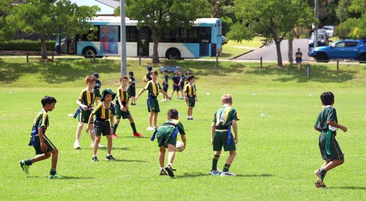 Group of students playing OZ Tag on an oval